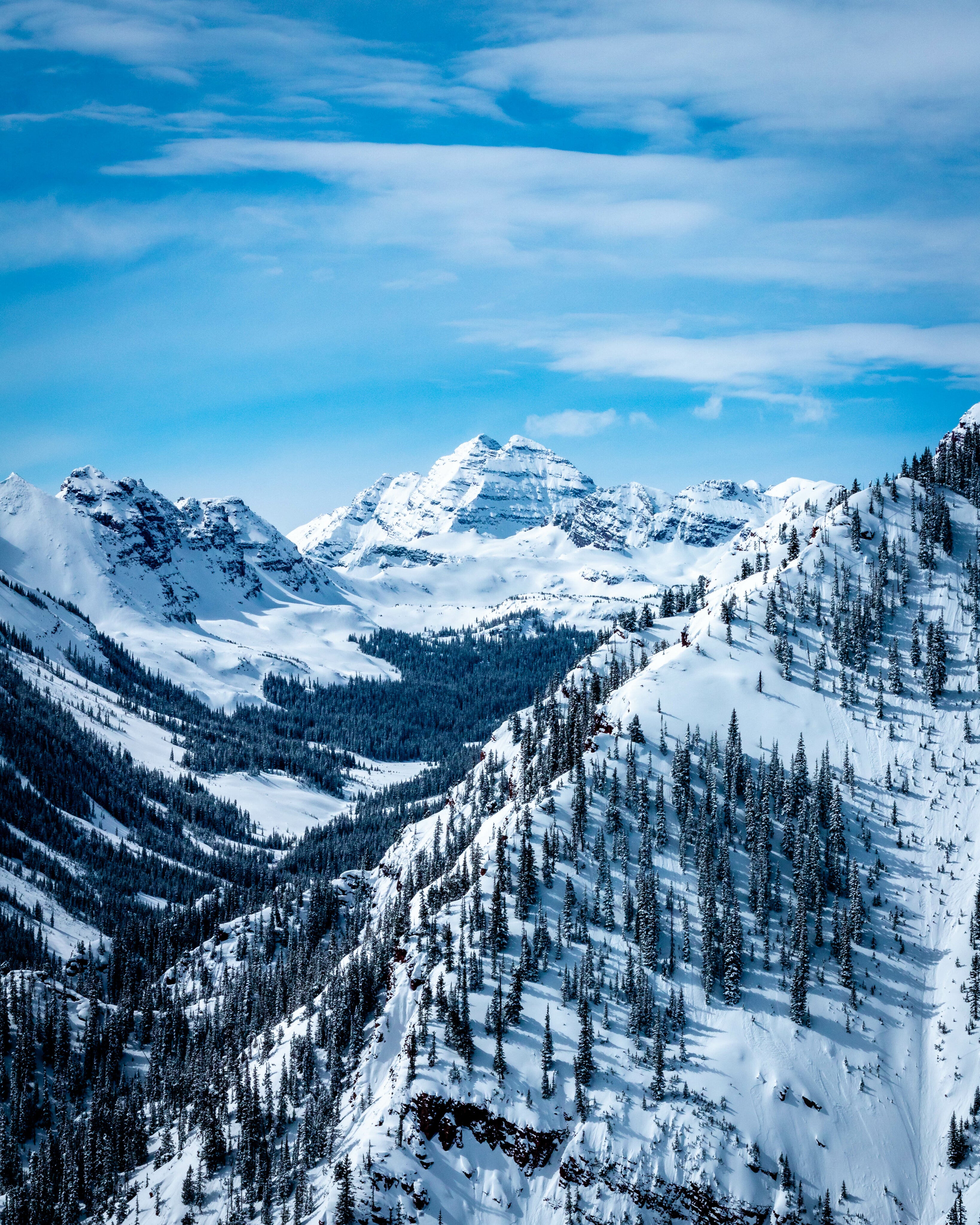 aerial-image-of-snow-covered-mountains-under-bright-sky.jpg